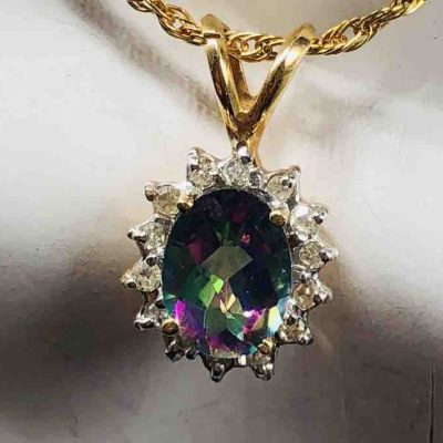 Small Oval Checker Board Caribbean Topaz Surrounded By Diamonds