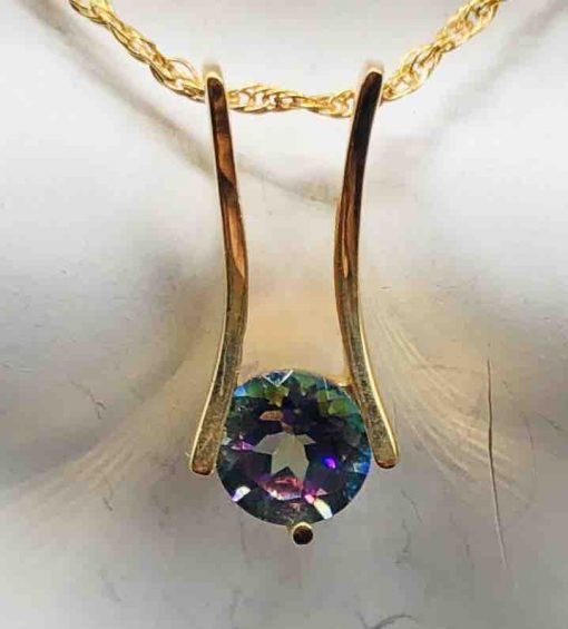 14 KT Yellow Gold 2 Bars Holding A Round Caribbean Topaz